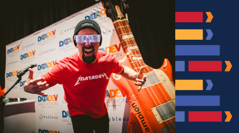 An excited man leaning toward the camera with a brightly colored background.